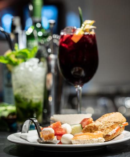 a plate with a sandwich and a drink on a table at Catalonia Born in Barcelona