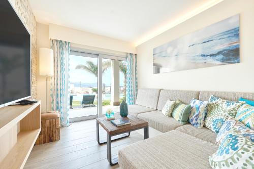a living room with a couch and a tv at 7Pines Resort Ibiza, part of Destination by Hyatt in San Jose
