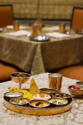 a tray of food on top of a table at Leisure Inn Grand Chanakya in Jaipur