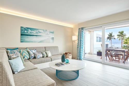 a living room with a couch and a table at 7Pines Resort Ibiza, part of Destination by Hyatt in San Jose