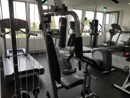 a gym with several tread machines in a room at Hotel Terminal One in Sindelfingen
