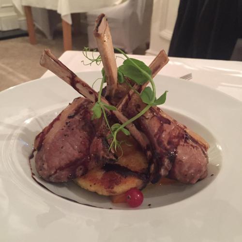a piece of meat on a white plate on a table at LLwyn Country House in Llanelli