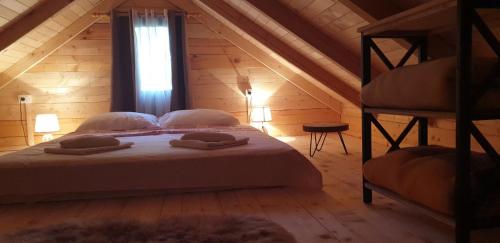 a bedroom with a bed in a wooden cabin at Little Paradise in Virpazar