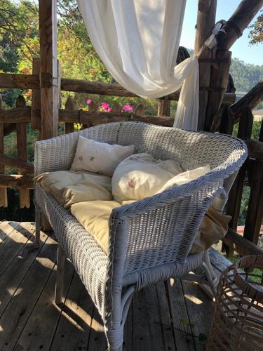 a wicker couch sitting on a porch at Bed & Breakfast Lujocanda in Casarza Ligure