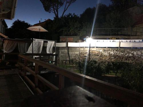 a fence with a light on top of a stone wall at Bed & Breakfast Lujocanda in Casarza Ligure