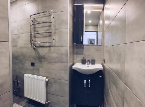 a bathroom with a sink and a mirror at Room1402 in Odesa