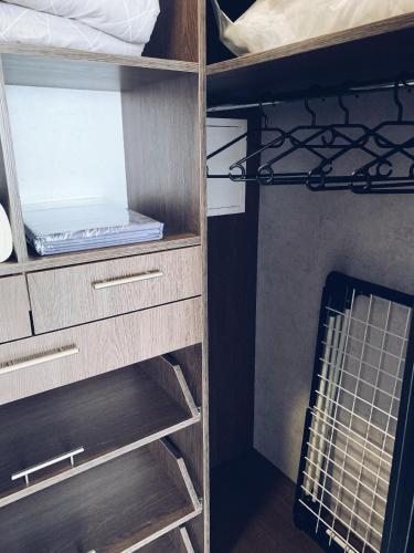a bunk bed with wooden shelves and drawers in a room at Room1402 in Odesa