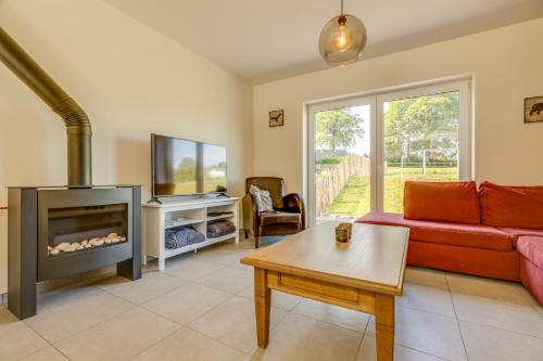 a living room with a couch and a fireplace at Maison LoKaKo in Waimes