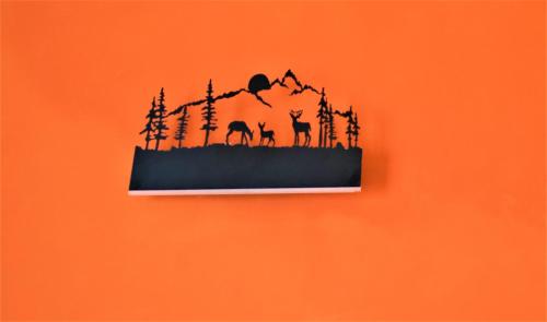 an orange wall with a black silhouette of animals on it at Hotel Nagarkot Inn in Nagarkot