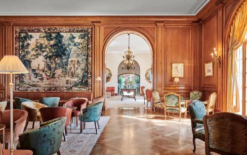 a room filled with furniture and a large painting on the wall at Château Saint-Martin & Spa, Oetker Hotels in Vence