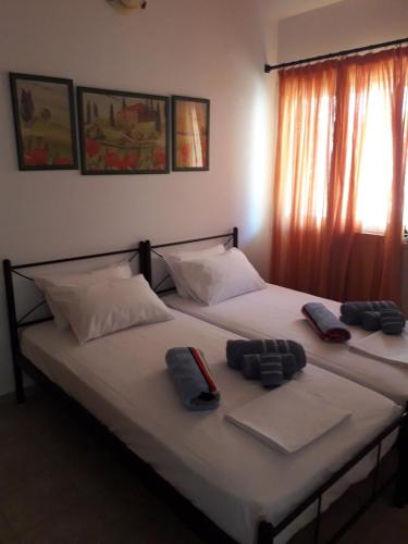 two beds sitting next to each other in a room at Ionian Balcony - Davgata in Dhavgáta