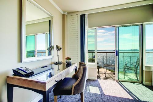 an office with a desk and a view of the water at The Woodmark Hotel & Still Spa on Lake Washington in Kirkland