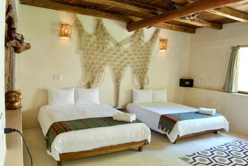 
A bed or beds in a room at Serena Tulum - Adults Only
