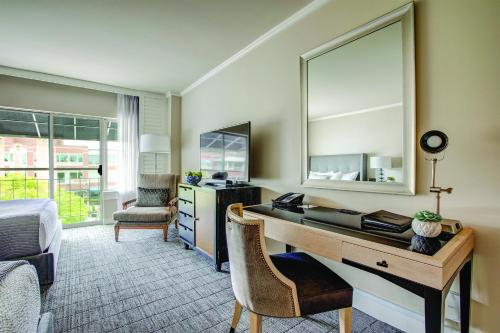 a room with a desk and a mirror at The Woodmark Hotel & Still Spa on Lake Washington in Kirkland