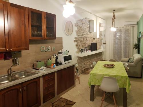 een keuken met een tafel met een groene tafelkleed erop bij Ai Carrettieri della Cattedrale in Palermo