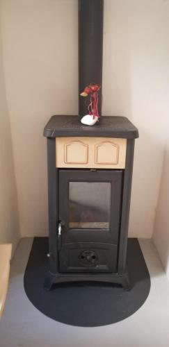 a small stove sitting in the corner of a room at Amaranti House n Art in Mandrakion