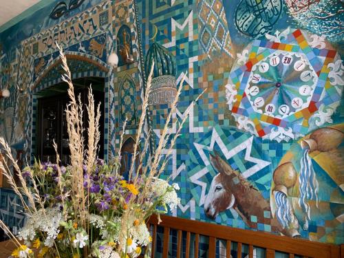 a mural on the wall of a room with flowers at Penzion U Dačické brány in Slavonice