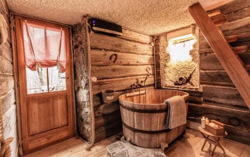 a wooden bathroom with a wooden tub and a door at Il Roccolino in Valsecca