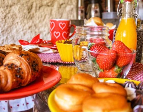 a table topped with plates of pastries and fruit at Il Roccolino in Valsecca