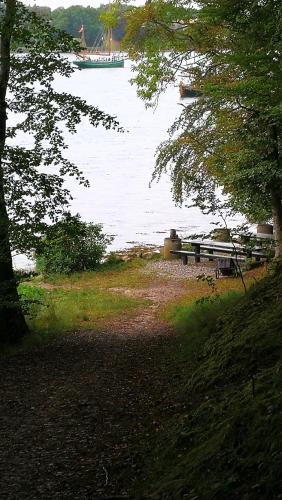 a view of a lake with a boat in the water at Kastanievejens overnatning in Svendborg