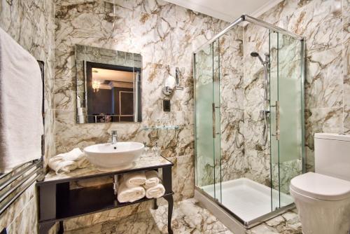 a bathroom with a sink and a shower at Julina Boutique Living in Mosta