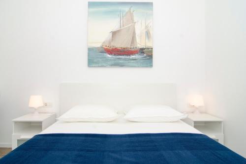 a bedroom with a bed with a sail boat in the water at Apartman M&D in Split