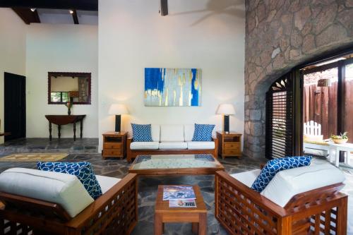 a living room with two couches and a fireplace at Stonefield Villa Resort in Soufrière