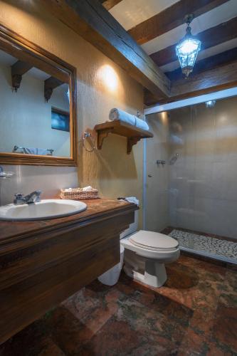 a bathroom with a sink and a toilet and a shower at Villa San Jose Hotel & Suites in Morelia