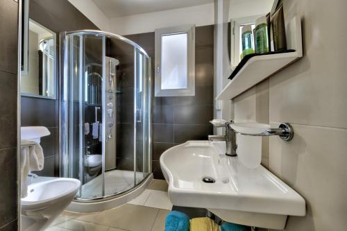 a bathroom with a sink and a shower at Residence Altomare in Riccione