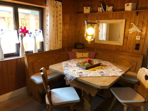 a dining room with a wooden table and chairs at Chalet am Hasensprung in Berchtesgaden