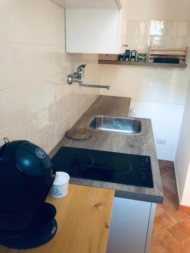 a kitchen with a sink and a counter top at San Michele delle grotte BnB in Gravina in Puglia
