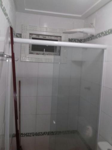 a shower with a glass door in a bathroom at Imóvel na Beira-Mar in Pipa