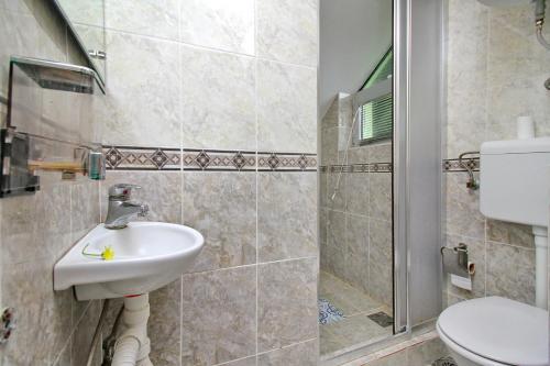 a bathroom with a sink and a shower at Tara lake apartments in Jevtići