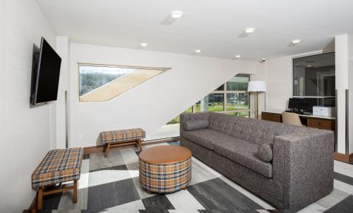 a living room with a couch and a table at Pomeroy Hotel Fort McMurray in Fort McMurray