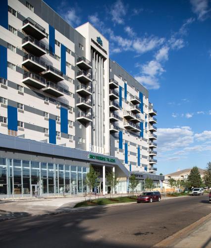 a building with balconies on the side of a street at Pomeroy Hotel Fort McMurray in Fort McMurray