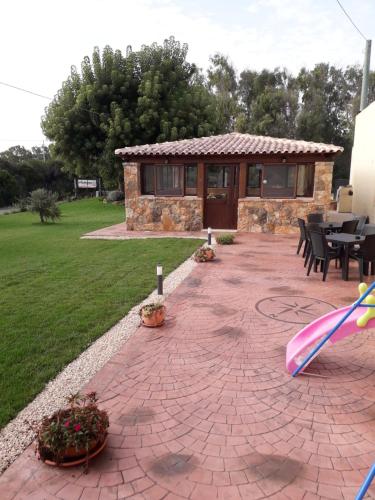 a brick patio with a house and a building at Agriturismo Quattro Mori in Porto Torres