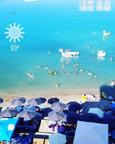 a group of people in the water at a beach at Marzi Boutique Hotel in Nerátza