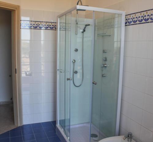 a glass shower in a bathroom with a toilet at BELICE APPARTAMENT in Salemi