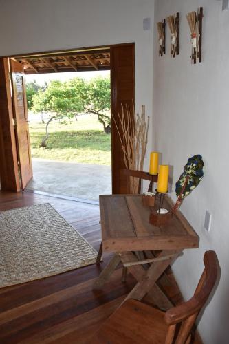 a room with a wooden table with a candle on it at Pousada Velho Bateau in Atins