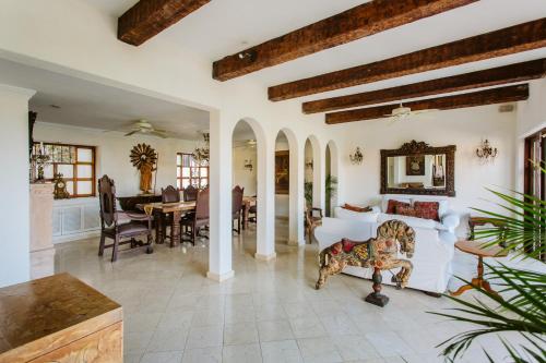 a living room with a couch and a dining room at Hacienda San Angel in Puerto Vallarta