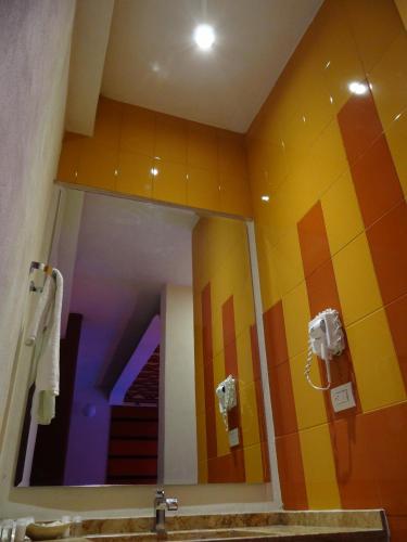 a bathroom with a mirror and a sink at Hotel Quinta Tlalpan in Mexico City