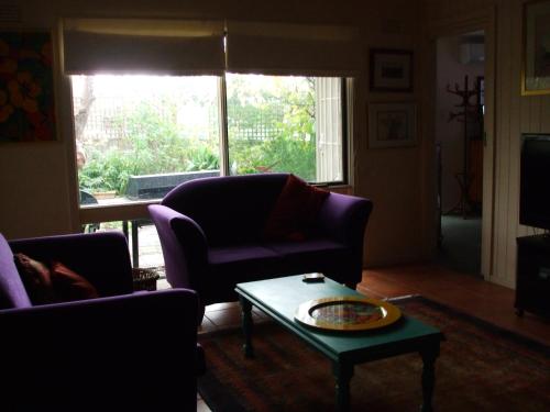 a living room with a couch and a coffee table at At the Gallery in Torquay