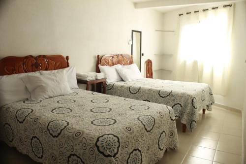 Giường trong phòng chung tại Hotel Posada Sernichari