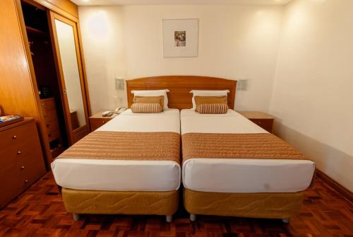 a bedroom with two beds in a room at City Garden Suites Manila in Manila