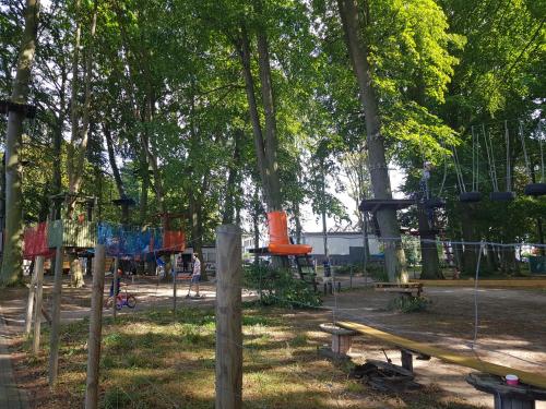 a park with a playground with a slide at Apartament "Złoty relaks" tuż przy plaży z balkonem z widokiem na Hel i hamakami in Puck