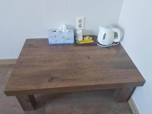a wooden table with a coffee maker and a box on it at Purmir Pension in Seogwipo
