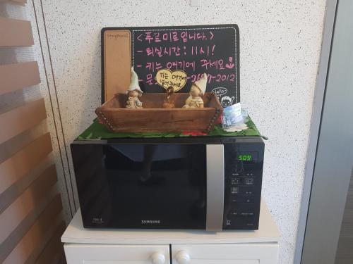 a microwave with figurines sitting on top of it at Purmir Pension in Seogwipo