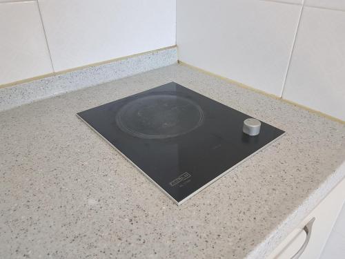 a counter top with a plate and a cup on it at Purmir Pension in Seogwipo