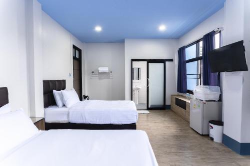 Katil atau katil-katil dalam bilik di Udomsuk Hotel