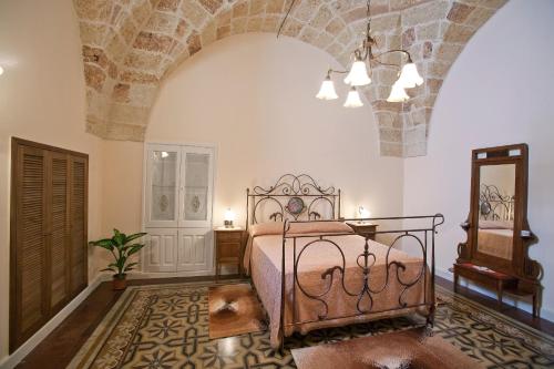 a bedroom with a bed and a mirror at Residencefusaro appartamenti Specchia in Specchia